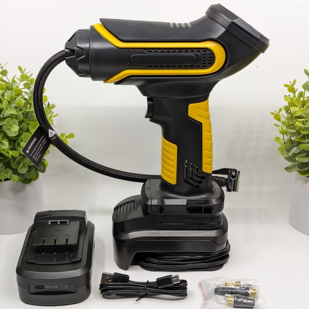 A handheld portable air compressor inflating a car tyre